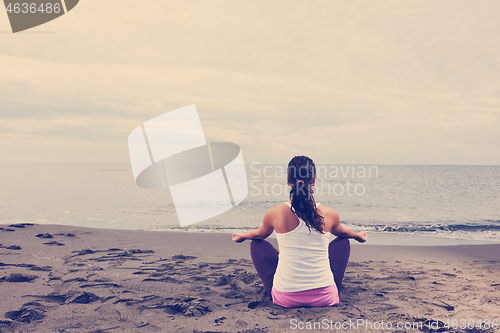 Image of woman yoga beach