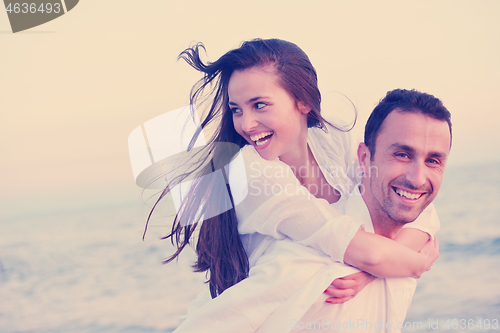 Image of young couple  on beach have fun