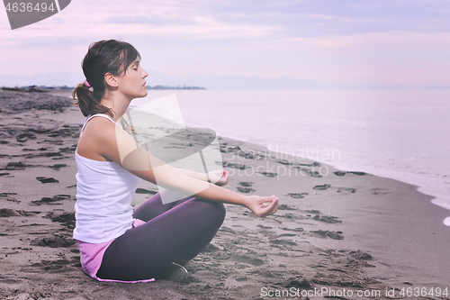 Image of woman yoga beach