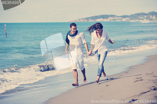 Image of happy young couple have fun at beautiful beach