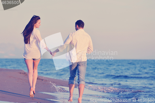 Image of young couple  on beach have fun