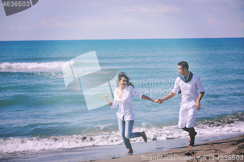 Image of happy young couple have fun at beautiful beach