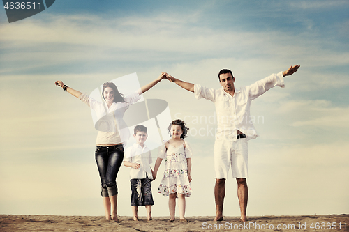 Image of family on beach showing home sign