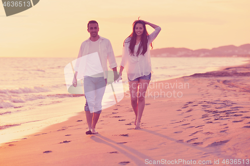 Image of young couple  on beach have fun