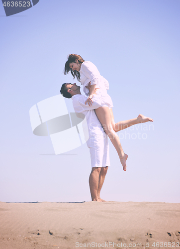 Image of happy young couple have fun on beach