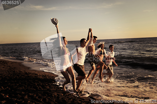 Image of people group running on the beach