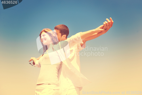 Image of happy young couple have fun on beach