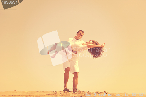 Image of happy young couple have fun on beach