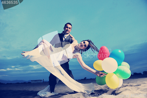 Image of romantic beach wedding at sunset