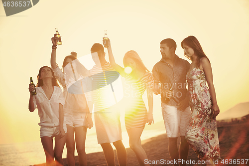 Image of Group of young people enjoy summer  party at the beach