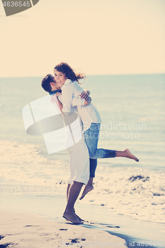 Image of happy young couple have fun at beautiful beach