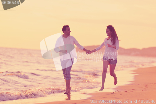 Image of young couple  on beach have fun