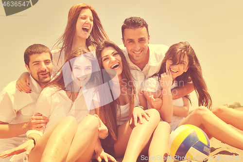 Image of Group of happy young people in have fun at beach