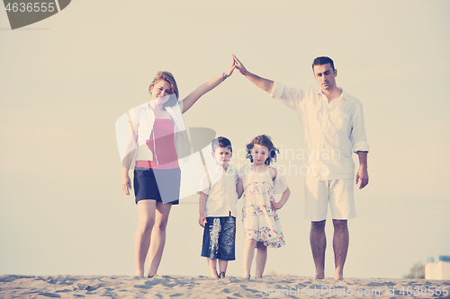 Image of family on beach showing home sign