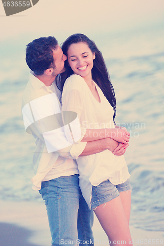 Image of young couple  on beach have fun