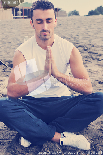 Image of man yoga beach