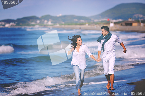 Image of happy young couple have fun at beautiful beach