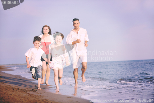 Image of happy young family have fun on beach