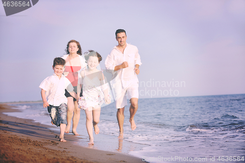 Image of happy young family have fun on beach