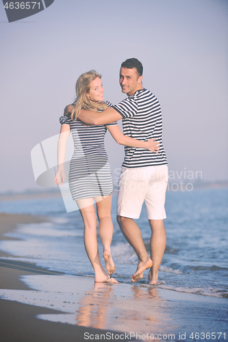 Image of happy young couple have romantic time on beach