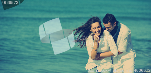 Image of happy young couple have fun at beautiful beach