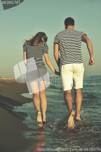 Image of happy young couple have romantic time on beach