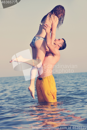 Image of happy young couple have fun on beach