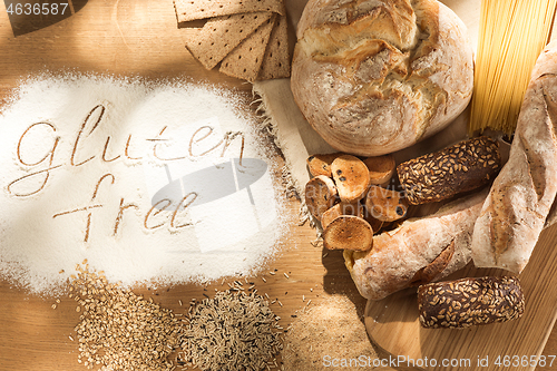 Image of Gluten free food. Various pasta, bread and snacks on wooden background from top view