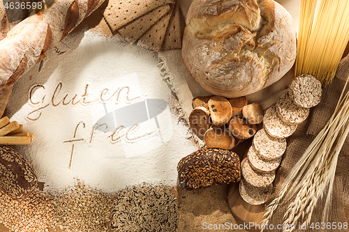 Image of Gluten free food. Various pasta, bread and snacks on wooden background from top view