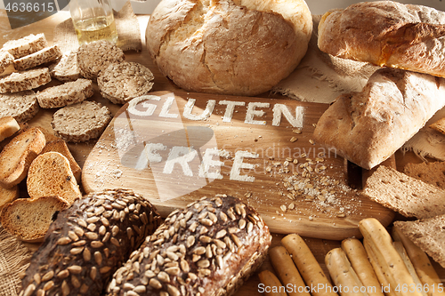 Image of Gluten free food. Various pasta, bread and snacks on wooden background from top view