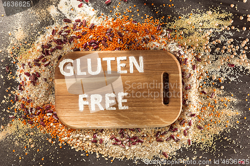 Image of Gluten free flour and cereals millet, quinoa, corn bread, brown buckwheat, rice with text gluten free