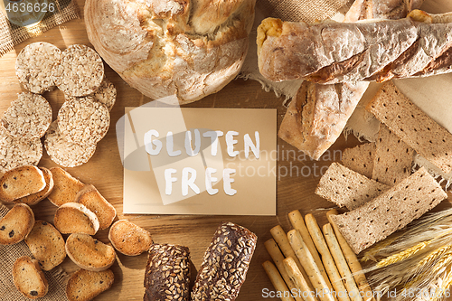 Image of Gluten free food. Various pasta, bread and snacks on wooden background from top view