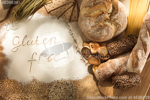 Image of Gluten free food. Various pasta, bread and snacks on wooden background from top view