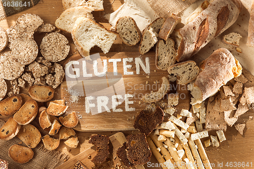 Image of Gluten free food. Various pasta, bread and snacks on wooden background from top view