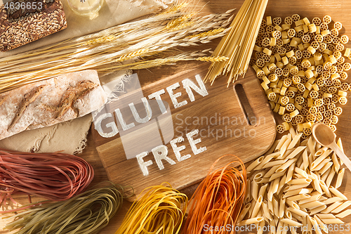 Image of Gluten free food. Various pasta, bread and snacks on wooden background from top view