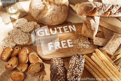 Image of Gluten free food. Various pasta, bread and snacks on wooden background from top view