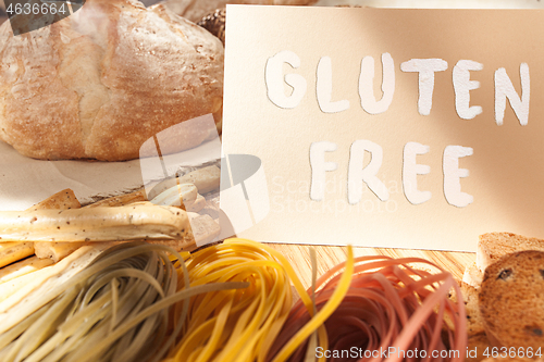 Image of Gluten free food. Various pasta, bread and snacks on wooden background from top view