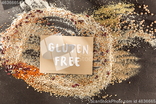 Image of Gluten free flour and cereals millet, quinoa, corn bread, brown buckwheat, rice with text gluten free