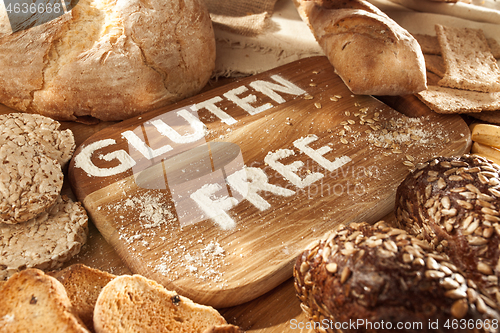 Image of Gluten free food. Various pasta, bread and snacks on wooden background from top view