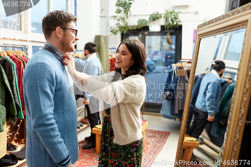 Image of couple choosing clothes at vintage clothing store