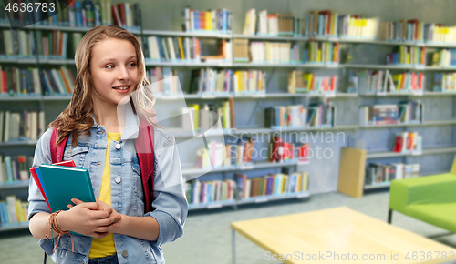 Image of teenage student girl with books at school library
