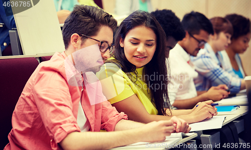 Image of group of international students writing at lecture