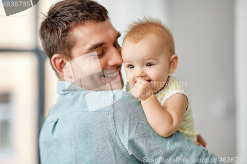 Image of happy father holding little baby daughter at home