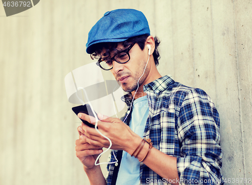 Image of man with earphones and smartphone listening music