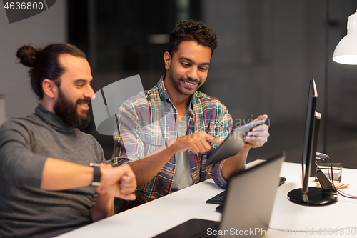 Image of creative team with tablet pc working at office