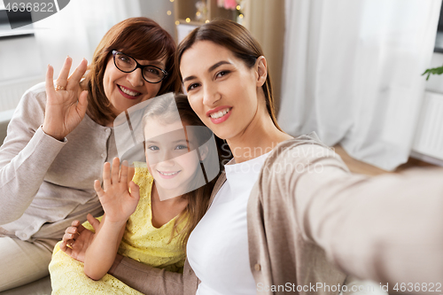 Image of mother, daughter and grandmother taking selfie