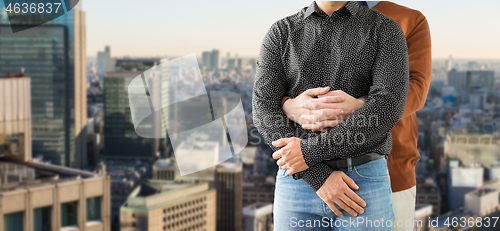 Image of close up of hugging male gay couple