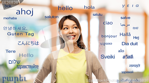 Image of asian woman looking up over foreign languages