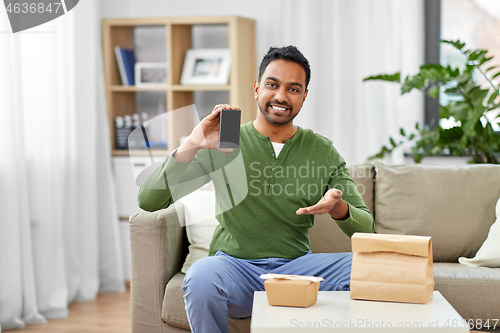 Image of indian man using smartphone for food delivery