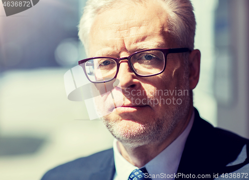 Image of close up of senior businessman in eyeglasses